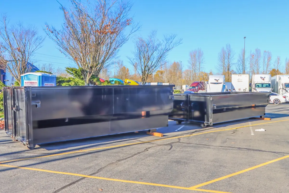 Professional dumpster rental service with roll-off container on residential driveway in Grand Prairie